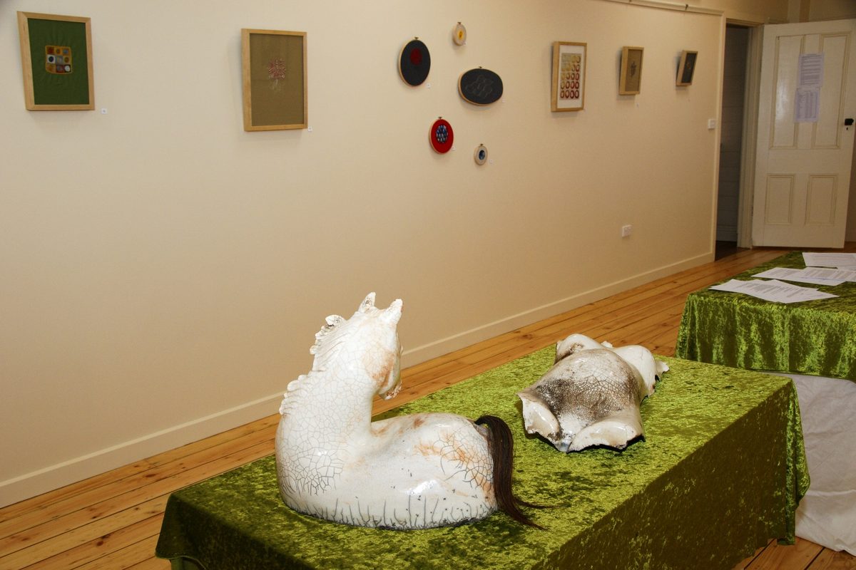 Ceramic sculptures and framed textile works displayed in the Frank Tate gallery